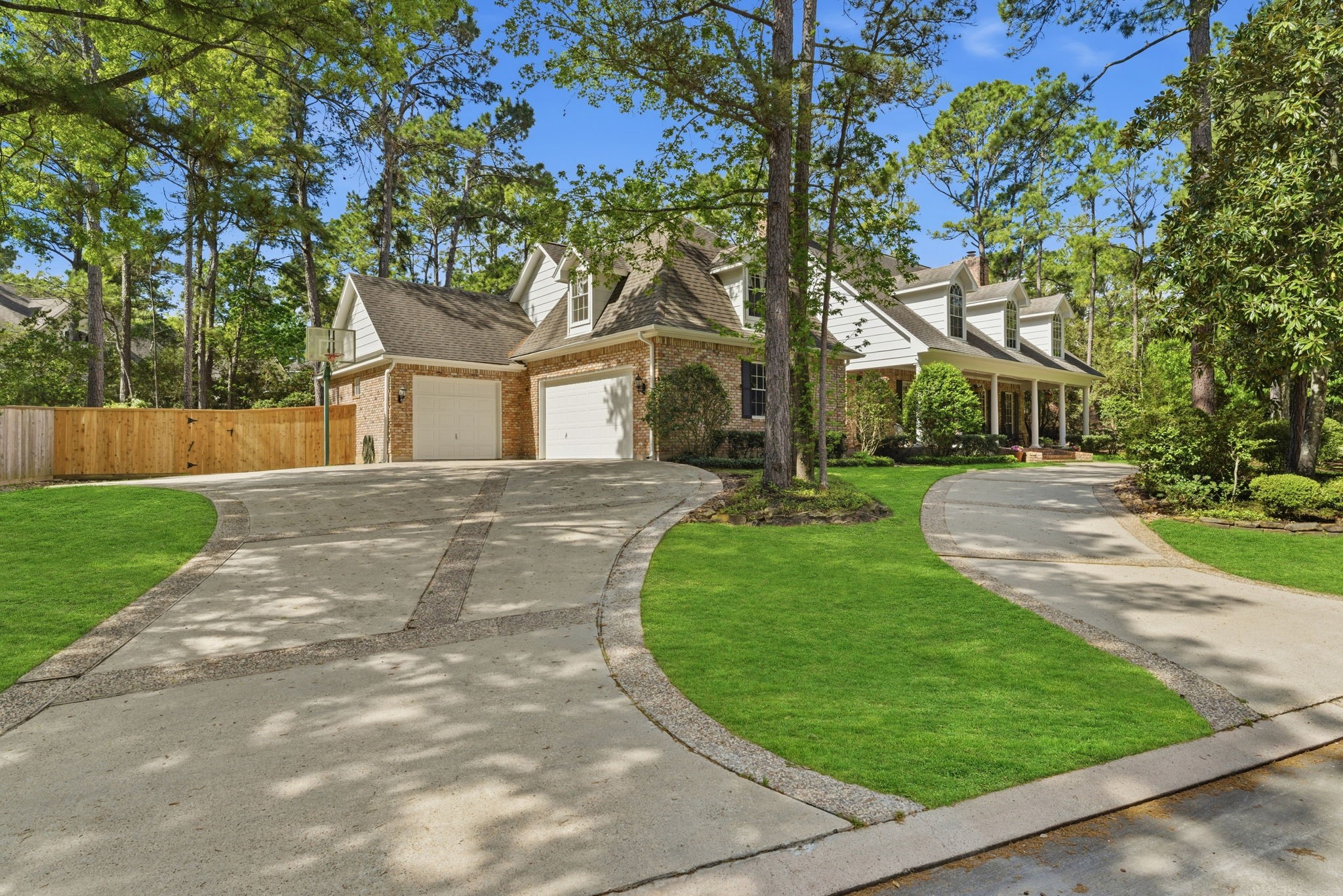 147 North Taylor Point Drive Spring, TX 77382 - Photo 41 of 44 A welcoming front-left view, featuring a spacious double driveway and lush greenery.