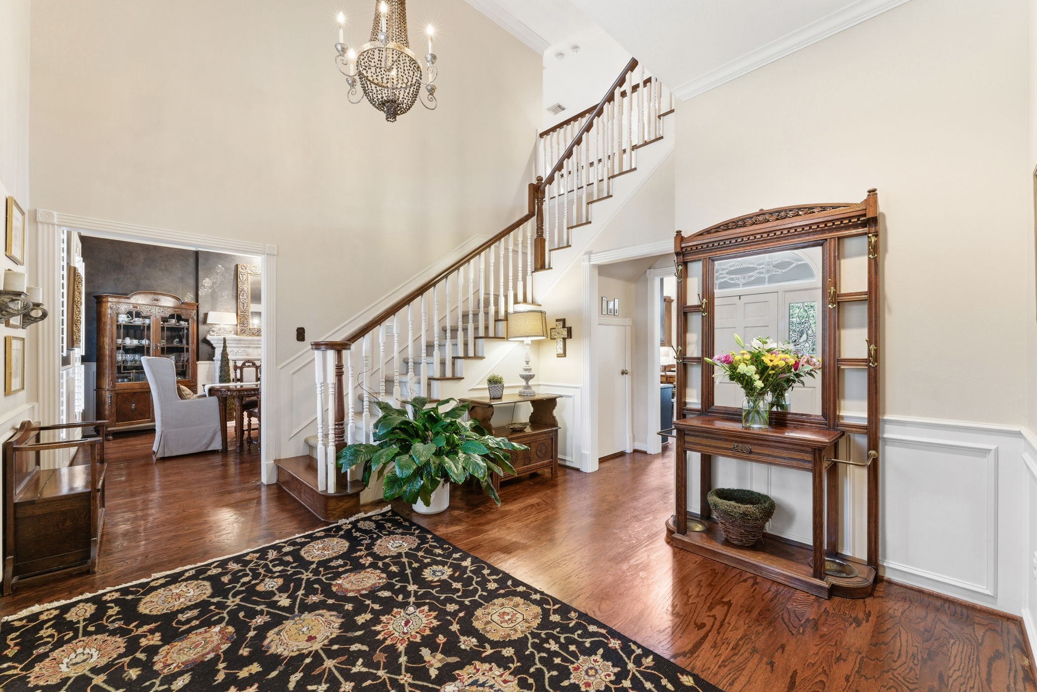147 North Taylor Point Drive Spring, TX 77382 - Photo 9 of 44 This charming home boasts a welcoming foyer with a graceful staircase and hardwood floors, leading into a serene backyard oasis perfect for relaxation and entertaining.