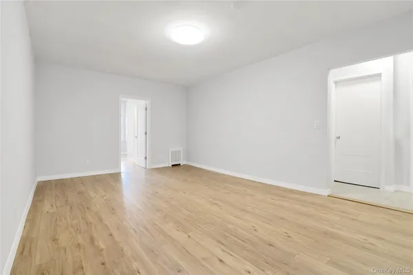 a view of an empty room and wooden floor
