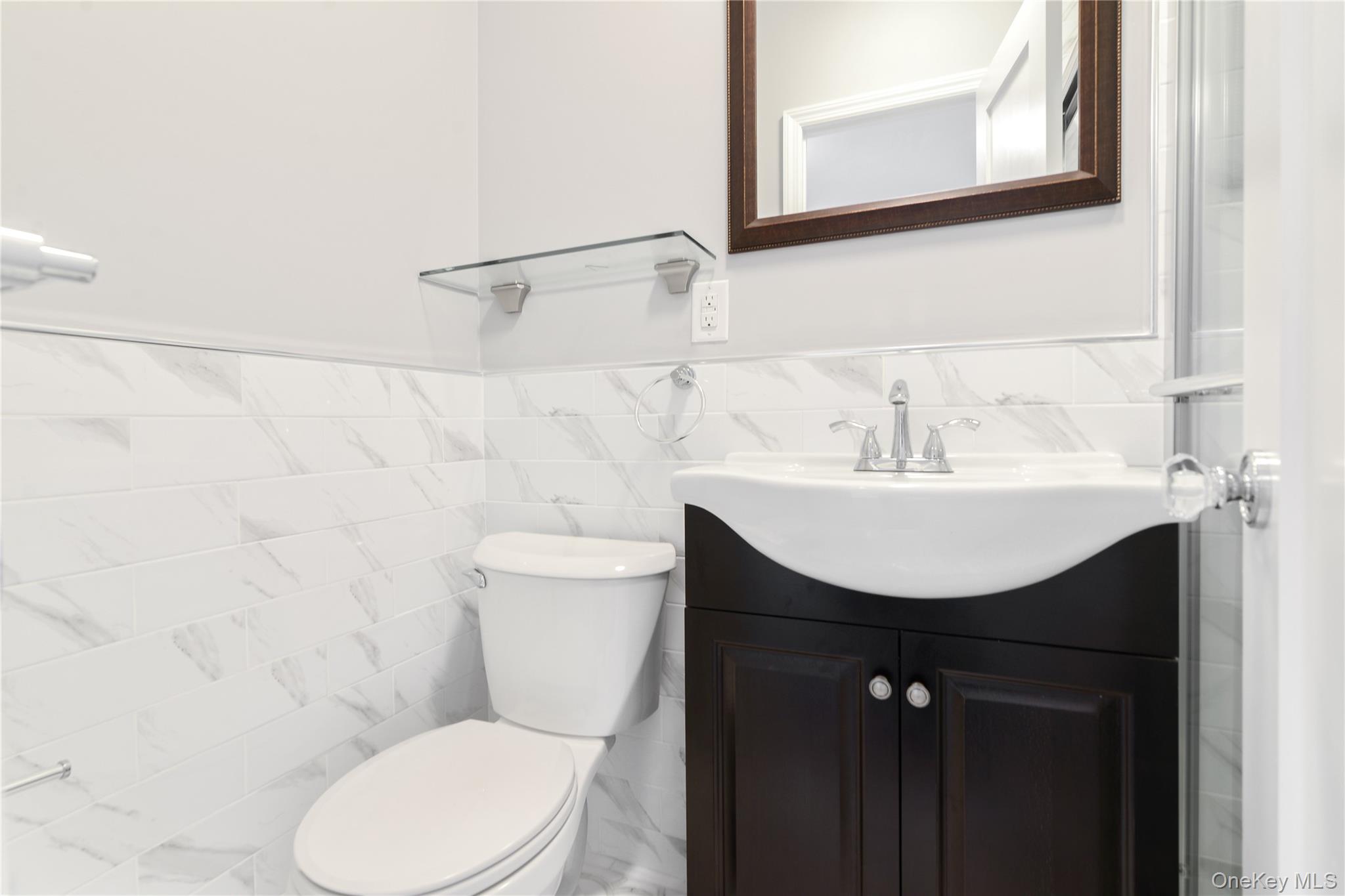 21-69 45th Street, Unit 3 Queens, NY 11105 - Photo 15 of 31 a bathroom with a sink toilet and mirror