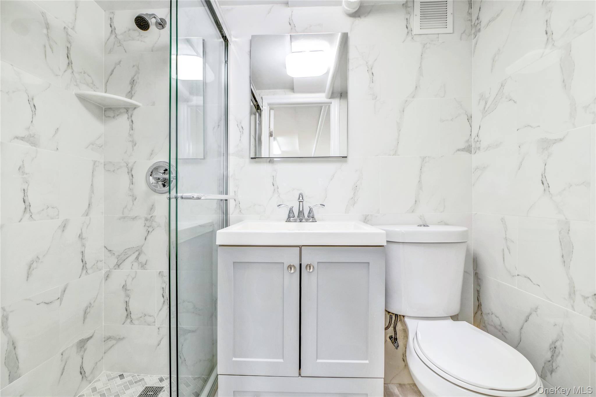 21-69 45th Street, Unit 3 Queens, NY 11105 - Photo 24 of 31 a bathroom with a sink a toilet and shower