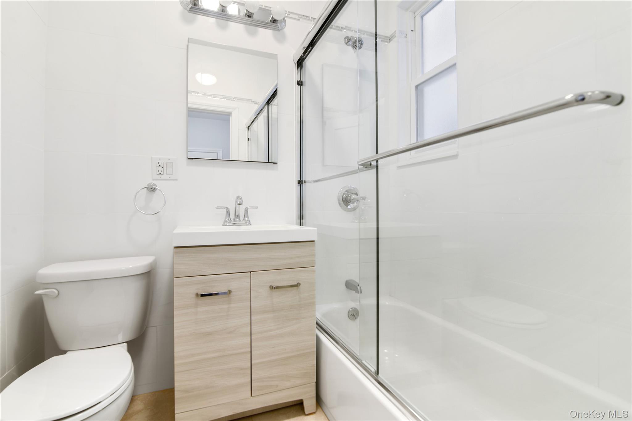 21-69 45th Street, Unit 3 Queens, NY 11105 - Photo 6 of 31 a bathroom with a sink a toilet and shower