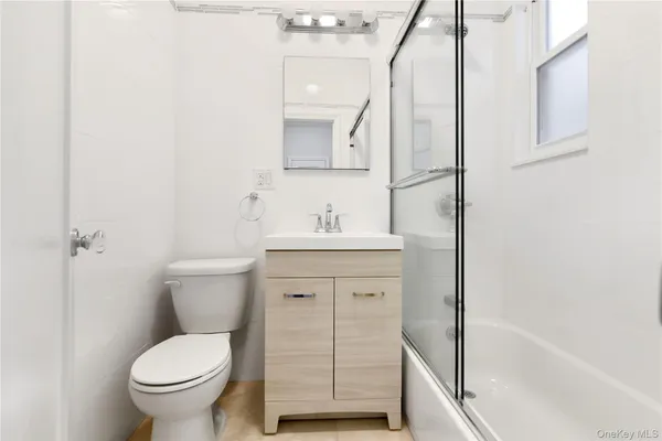 a bathroom with a toilet sink and a mirror