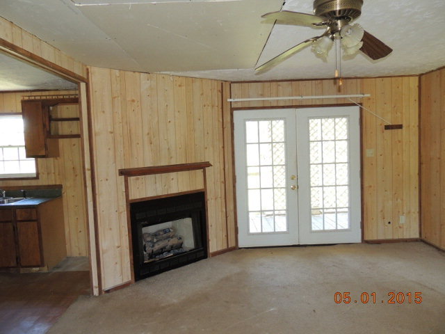 686 Tanglewood Road Fort Valley, GA 31030 - Photo 4 of 9 a living room with a fireplace and a window