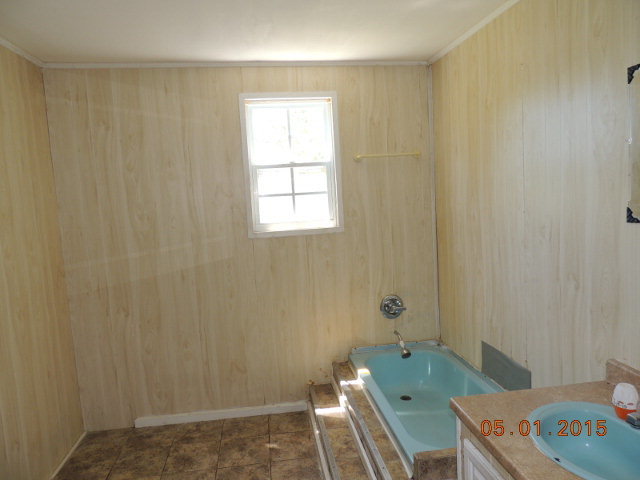 686 Tanglewood Road Fort Valley, GA 31030 - Photo 8 of 9 a bathroom with a sink toilet and shower