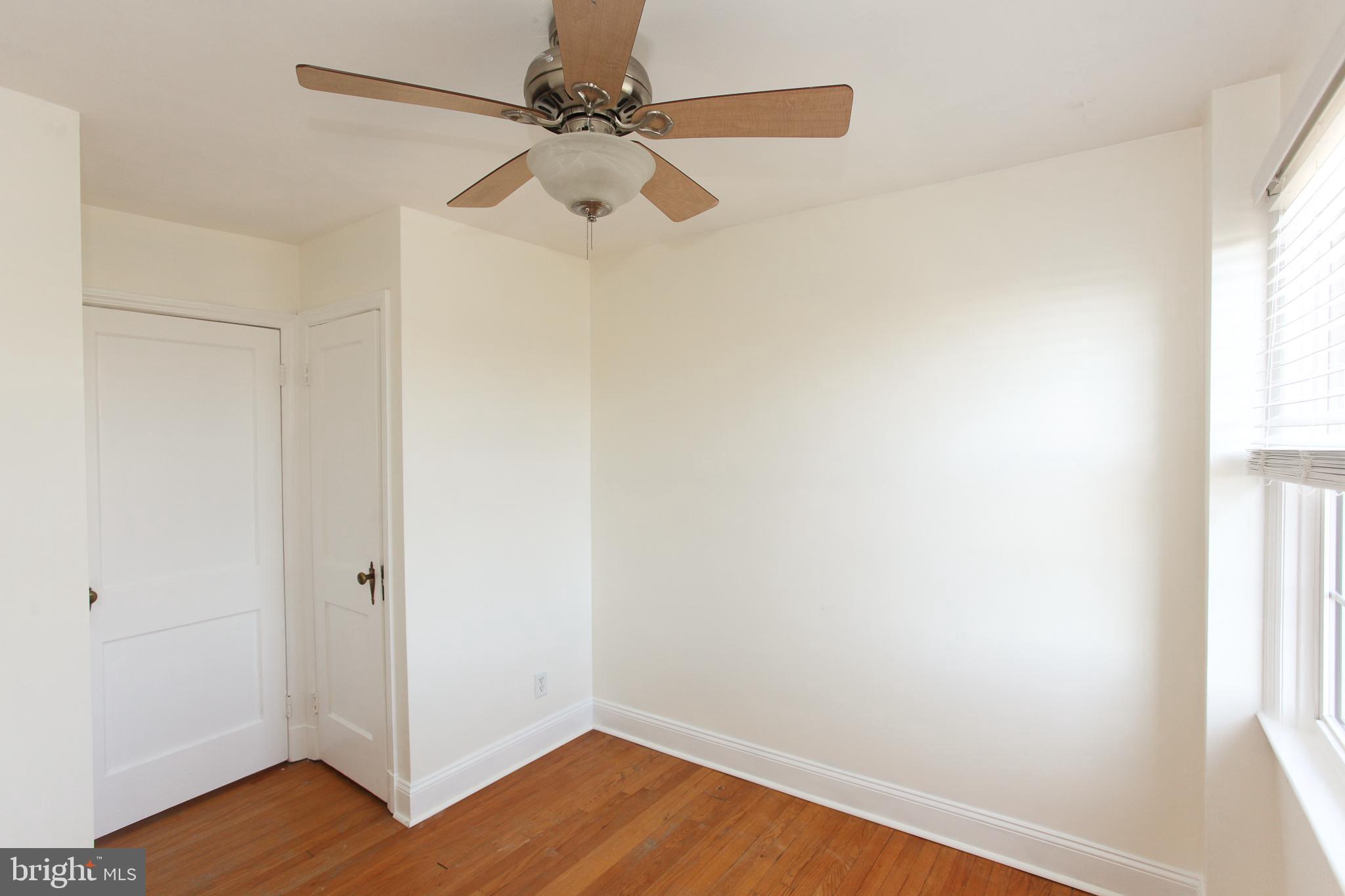 323 Greenlow Road Catonsville, MD 21228 - Photo 20 of 38 an empty room with wooden floor and windows