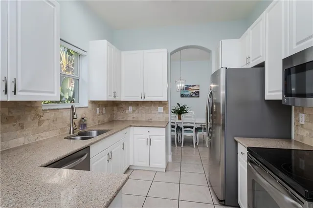 a kitchen with a sink cabinets and stainless steel appliances