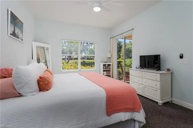 a bedroom with a large bed and a flat screen tv