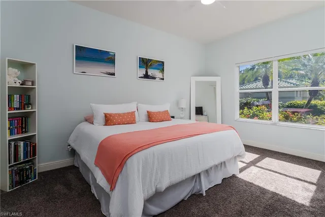 a bedroom with bed and a large window