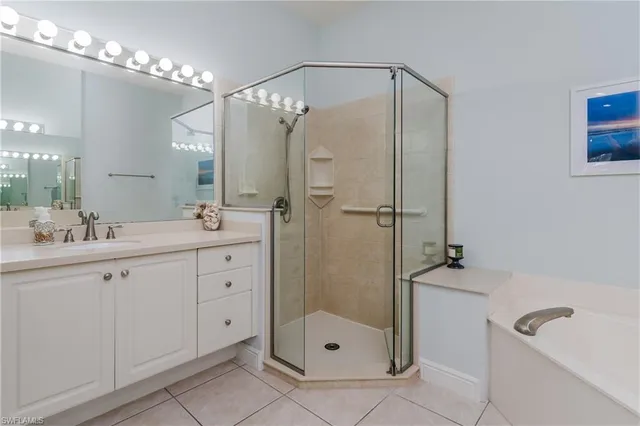a bathroom with a shower sink and mirror