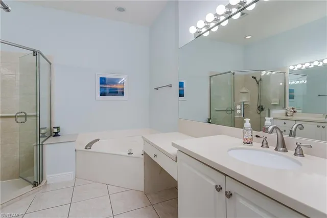 a bathroom with a sink a large mirror and a bathtub