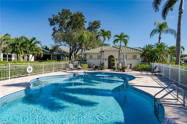 a view of swimming pool with a table and chairs