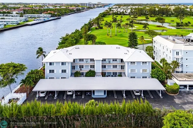 an aerial view of a house with outdoor space and lake view in back