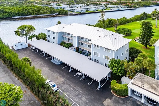 an aerial view of a house with garden space and a patio