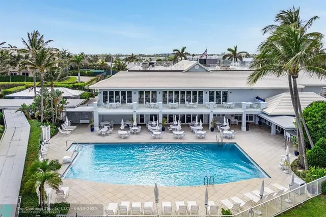 a view of a building with garden space and sitting area