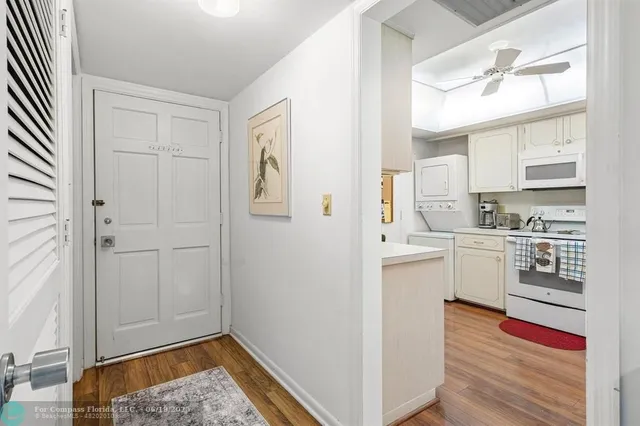 a kitchen with white cabinets and white appliances
