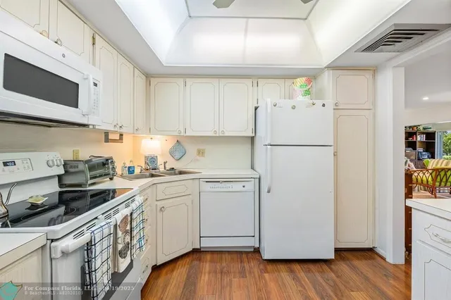 a kitchen with a refrigerator a stove a microwave and cabinets