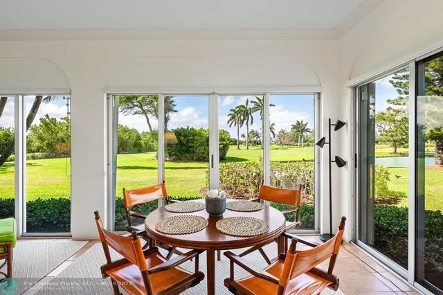 a dining room with furniture water view and a backyard