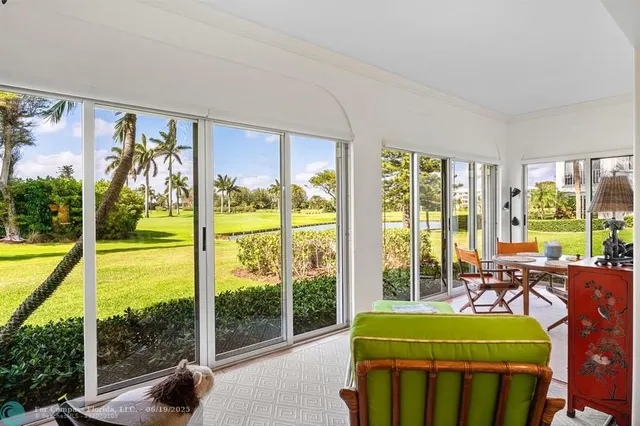 a room with pool table and chairs