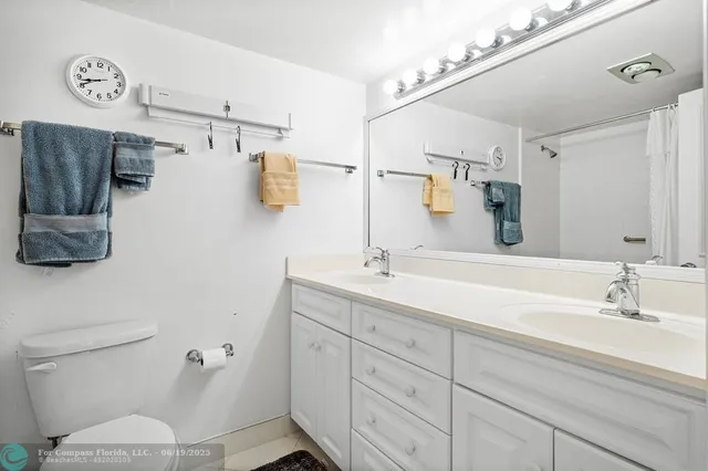 a bathroom with a sink a toilet and mirror
