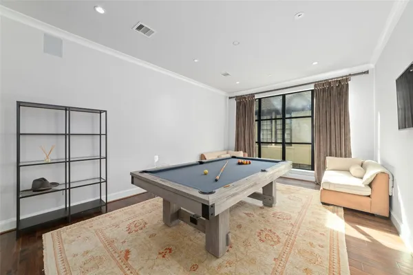 a living room with a book shelf and a book shelf