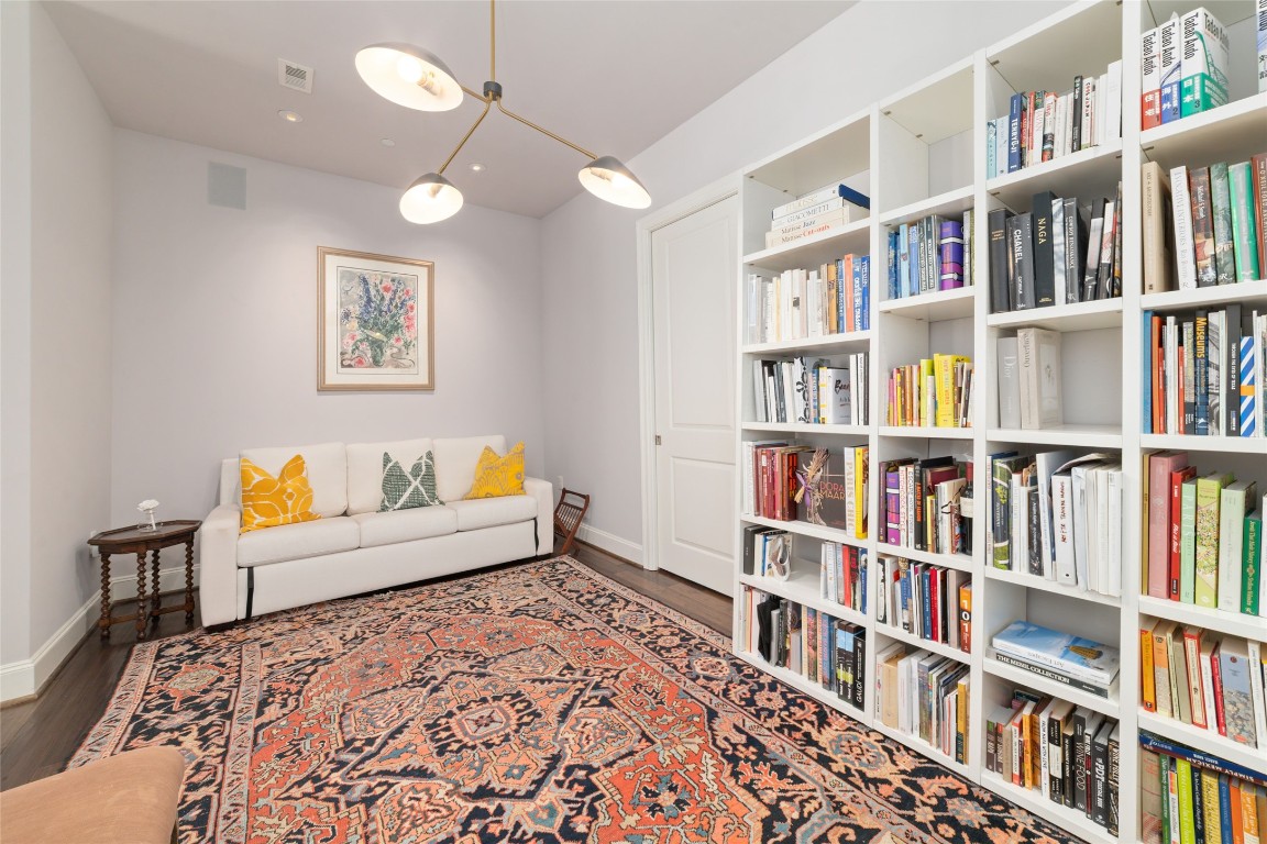 2221 Welch Street, Unit 201 Houston, TX 77019 - Photo 20 of 49 a living room with a book shelf and a book shelf