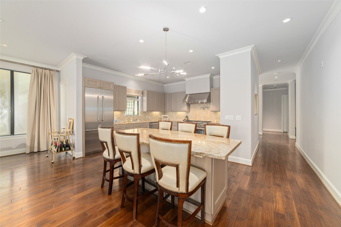 2221 Welch Street, Unit 201 Houston, TX 77019 - Photo 21 of 49 Down another long hallway, you enter the heart of the home; a true chef's kitchen with a large island and seating for at least 6 under a custom chandelier.