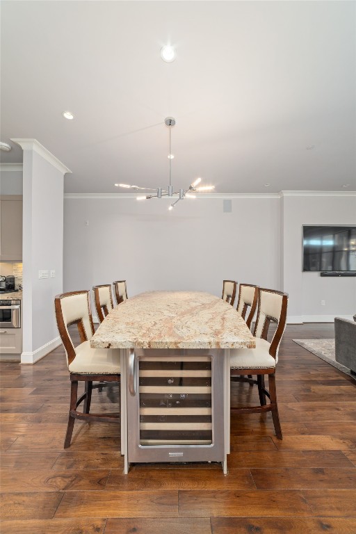 2221 Welch Street, Unit 201 Houston, TX 77019 - Photo 27 of 49 Another view of the expansive island topped with mesmerizing marble countertops and built-in wine refrigerator, creating a striking centerpiece that blends beauty, scale, and functionality.