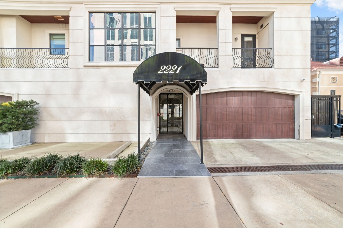 2221 Welch Street, Unit 201 Houston, TX 77019 - Photo 3 of 49 a front view of a house with a garden