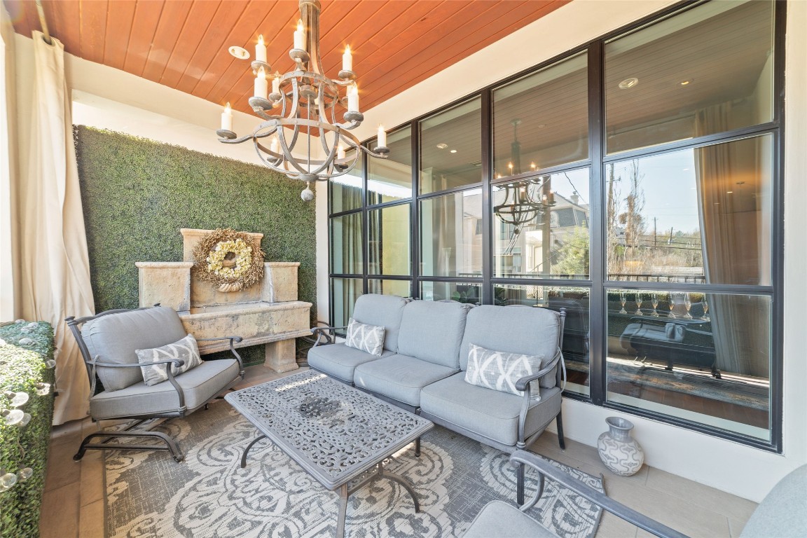 2221 Welch Street, Unit 201 Houston, TX 77019 - Photo 32 of 49 a living room with furniture and a chandelier