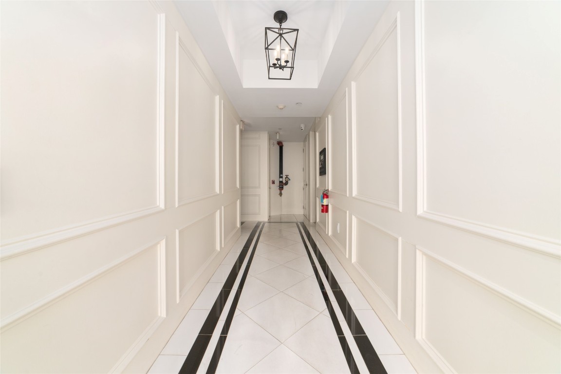 2221 Welch Street, Unit 201 Houston, TX 77019 - Photo 43 of 49 The building showcases timeless architectural design, highlighted by elegant neutral wall trim and clean tile flooring that create a polished and welcoming entry.