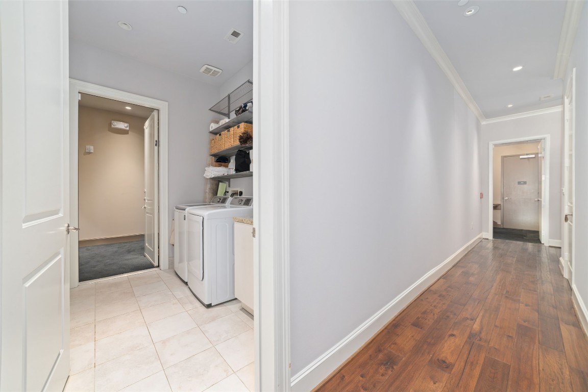 2221 Welch Street, Unit 201 Houston, TX 77019 - Photo 6 of 49 a view of a hallway with wooden floor and cabinet