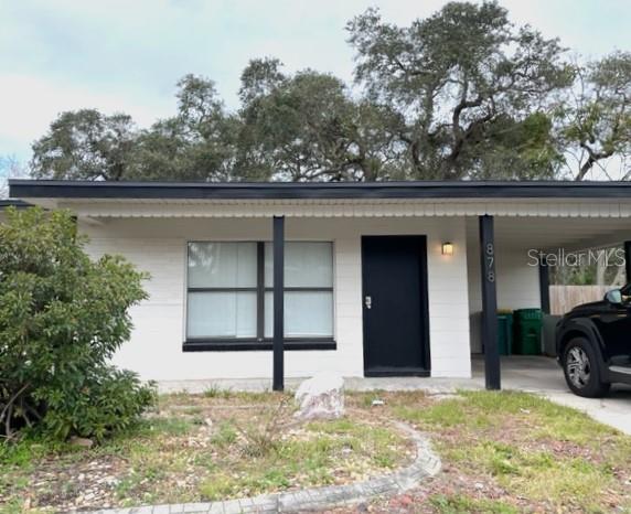 878 Sarno Road Melbourne, FL 32935 - Photo 1 of 1 a view of a house with a yard and garage