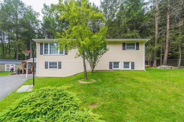 a front view of house with yard and green space