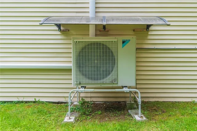 a green bench sitting in front of a window