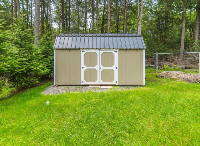 a view of a house with a yard and tree