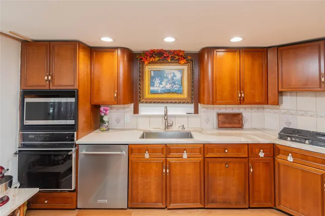 a kitchen with stainless steel appliances granite countertop a sink and cabinets