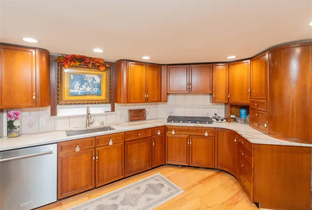 a kitchen with a sink cabinets and window