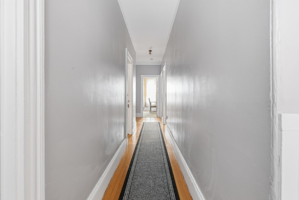35 Algonquin Street Boston, MA 02124 - Photo 22 of 32 a view of a hallway with wooden floor