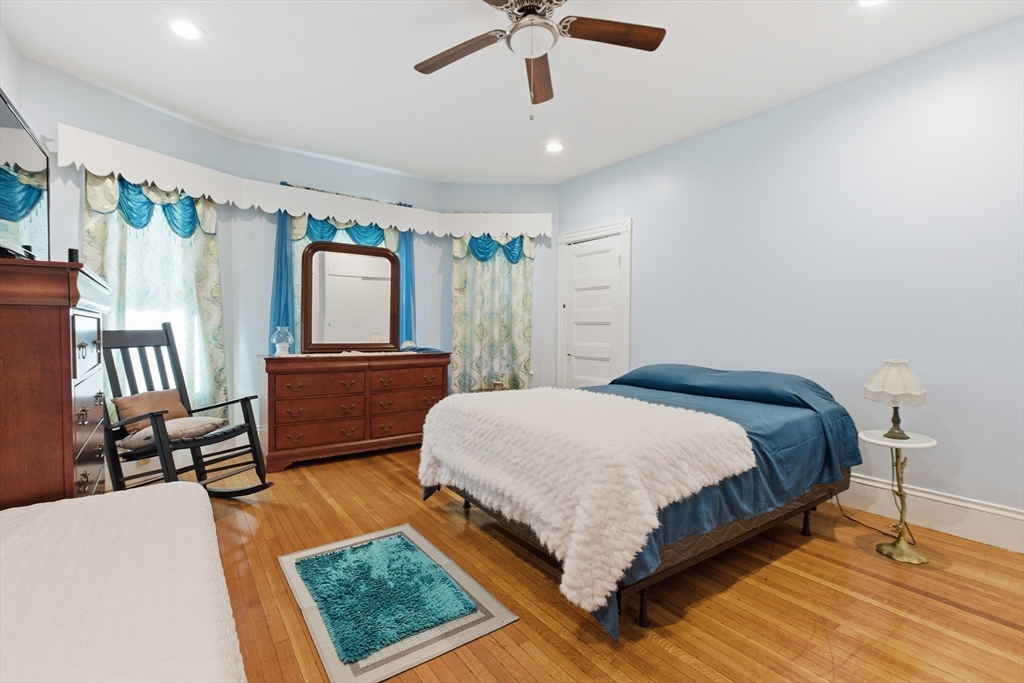 35 Algonquin Street Boston, MA 02124 - Photo 23 of 32 a bedroom with a bed window and a ceiling fan