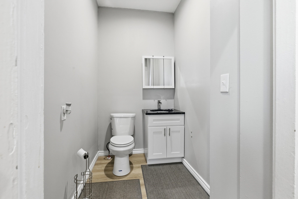 35 Algonquin Street Boston, MA 02124 - Photo 25 of 32 a bathroom with a toilet a sink and a window
