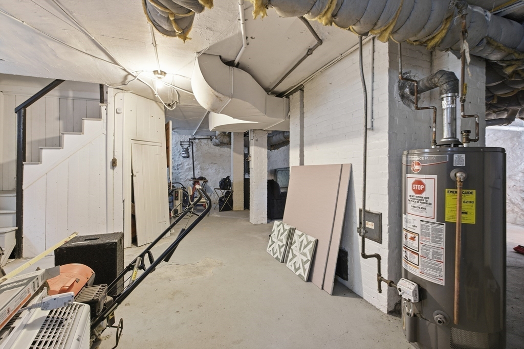 35 Algonquin Street Boston, MA 02124 - Photo 31 of 32 a view of walk in closet with clothes and shoes