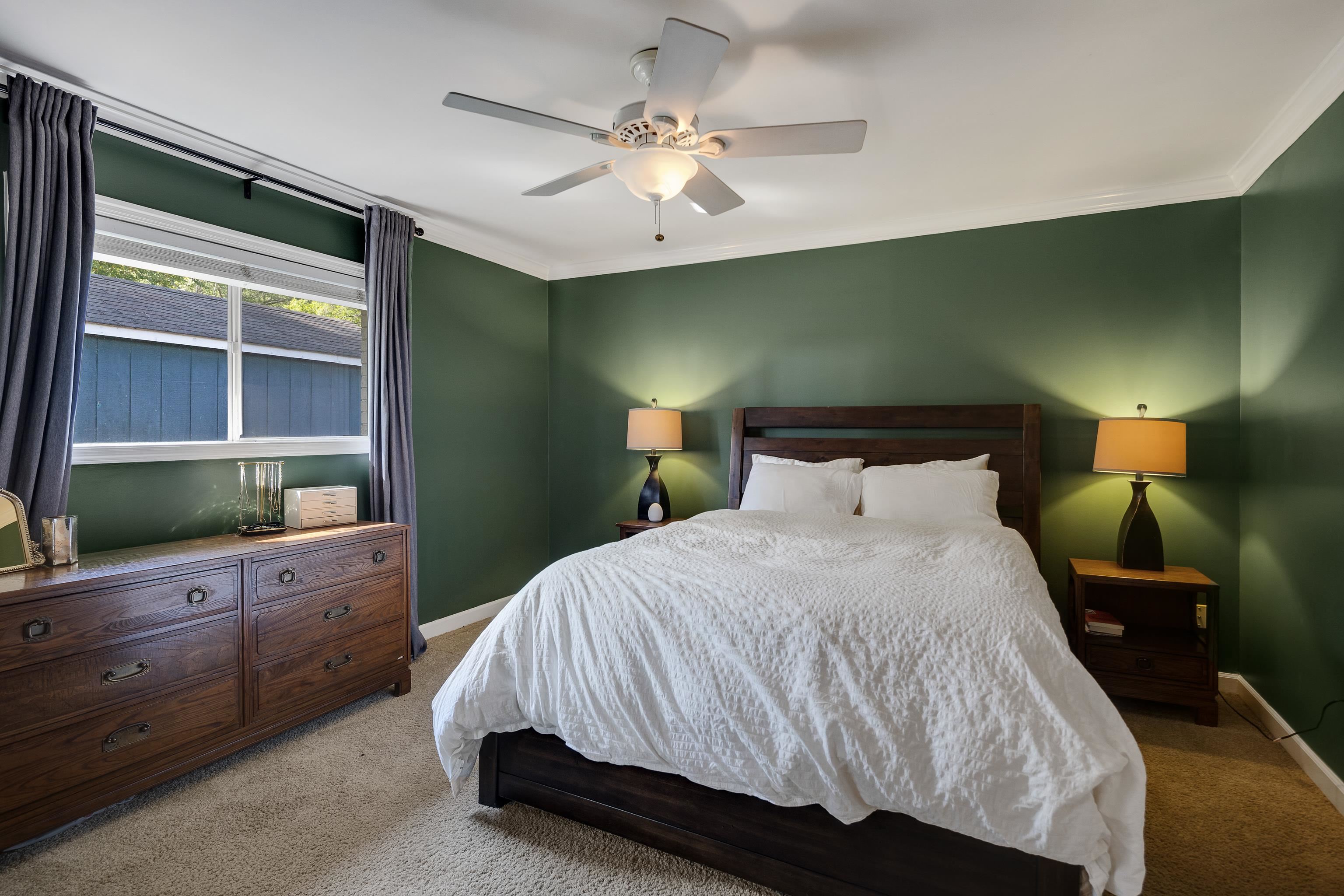 1269 West Perkins Road Memphis, TN 38117 - Photo 22 of 31 a bedroom with a large bed and a flat tv screen on dresser