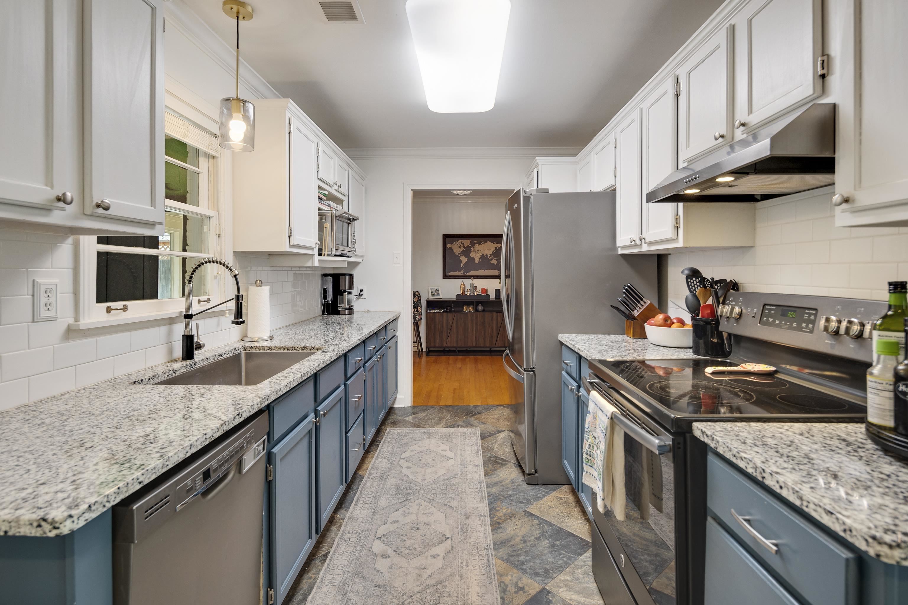 1269 West Perkins Road Memphis, TN 38117 - Photo 10 of 31 a kitchen with stainless steel appliances granite countertop a sink a stove and a wooden cabinets