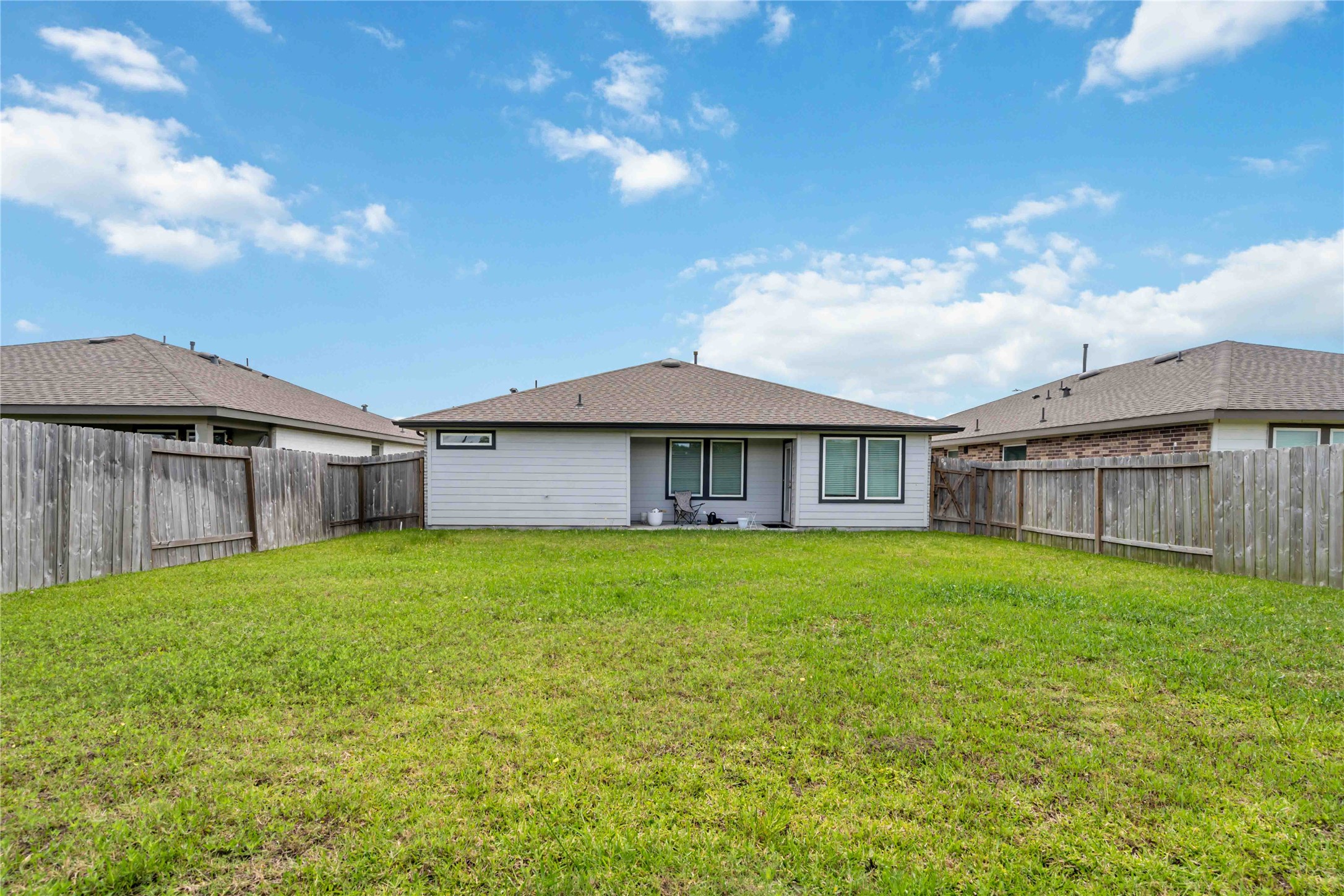 7730 Robert Rosharon, TX 77583 - Photo 18 of 18 Beautiful backyard with lush greenery, patio space, and room for outdoor enjoyment.