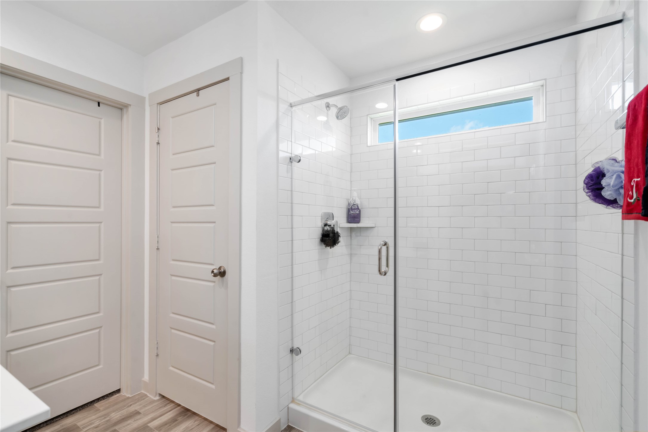 7730 Robert Rosharon, TX 77583 - Photo 9 of 18 Walk-in shower with floor-to-ceiling subway tile, glass enclosure, and a large picture window for natural light.