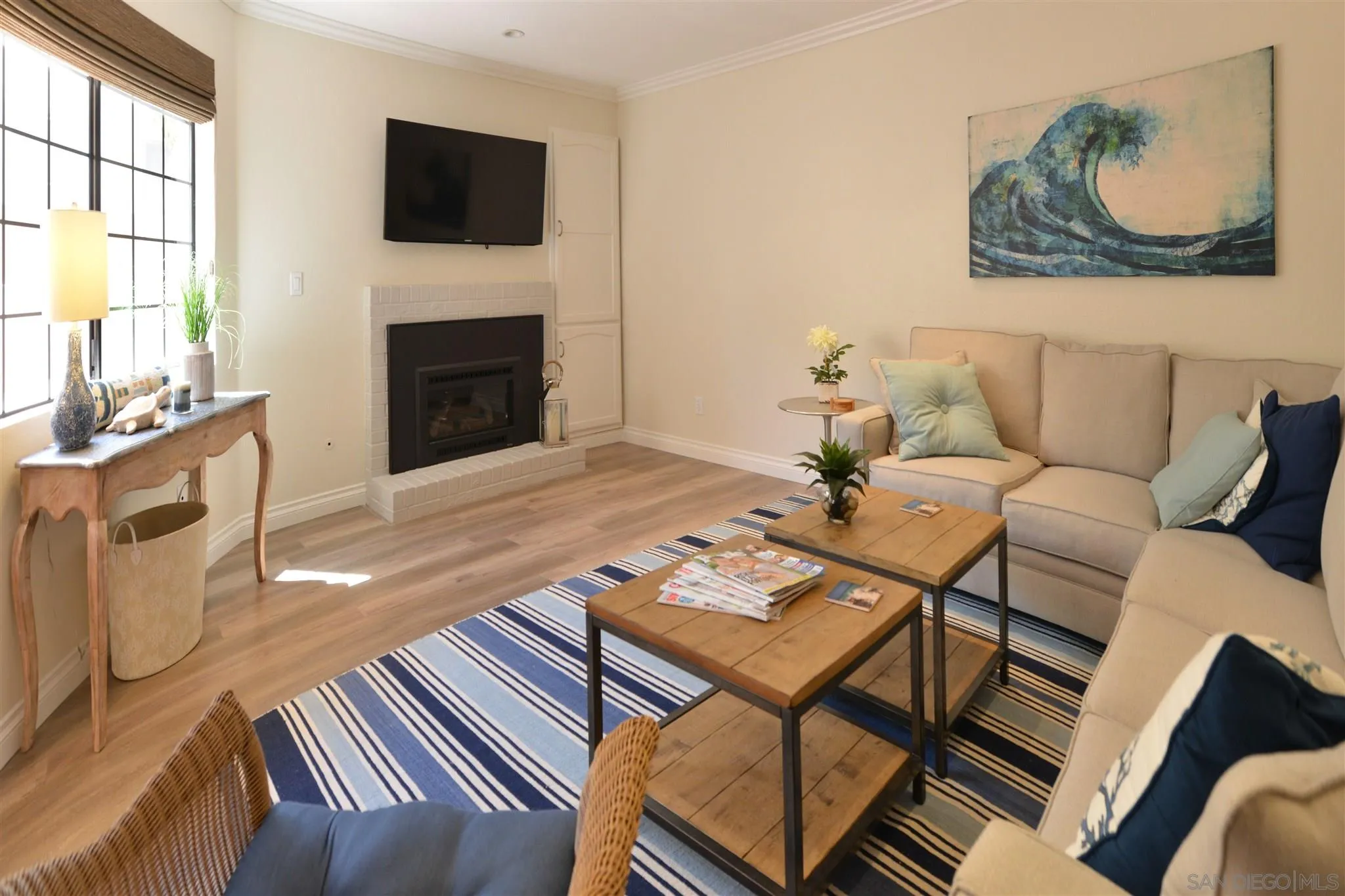 554 E Coronado, CA 92118 - Photo 2 of 13 a living room with furniture a fireplace and a flat screen tv