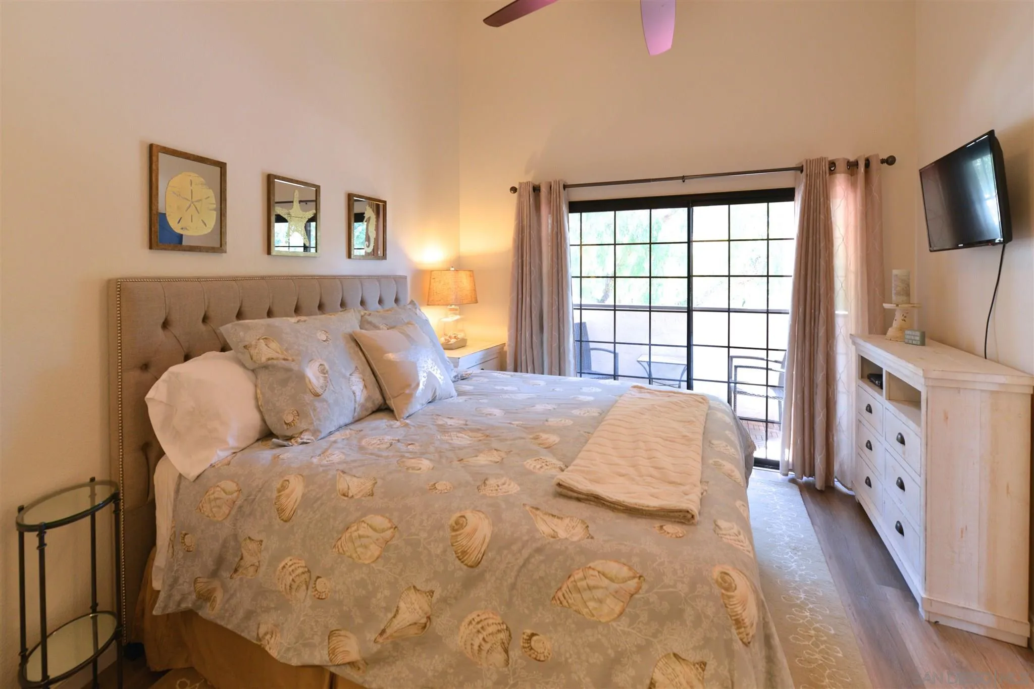 554 E Coronado, CA 92118 - Photo 4 of 13 a bed sitting in a bedroom next to a window with a flat screen tv