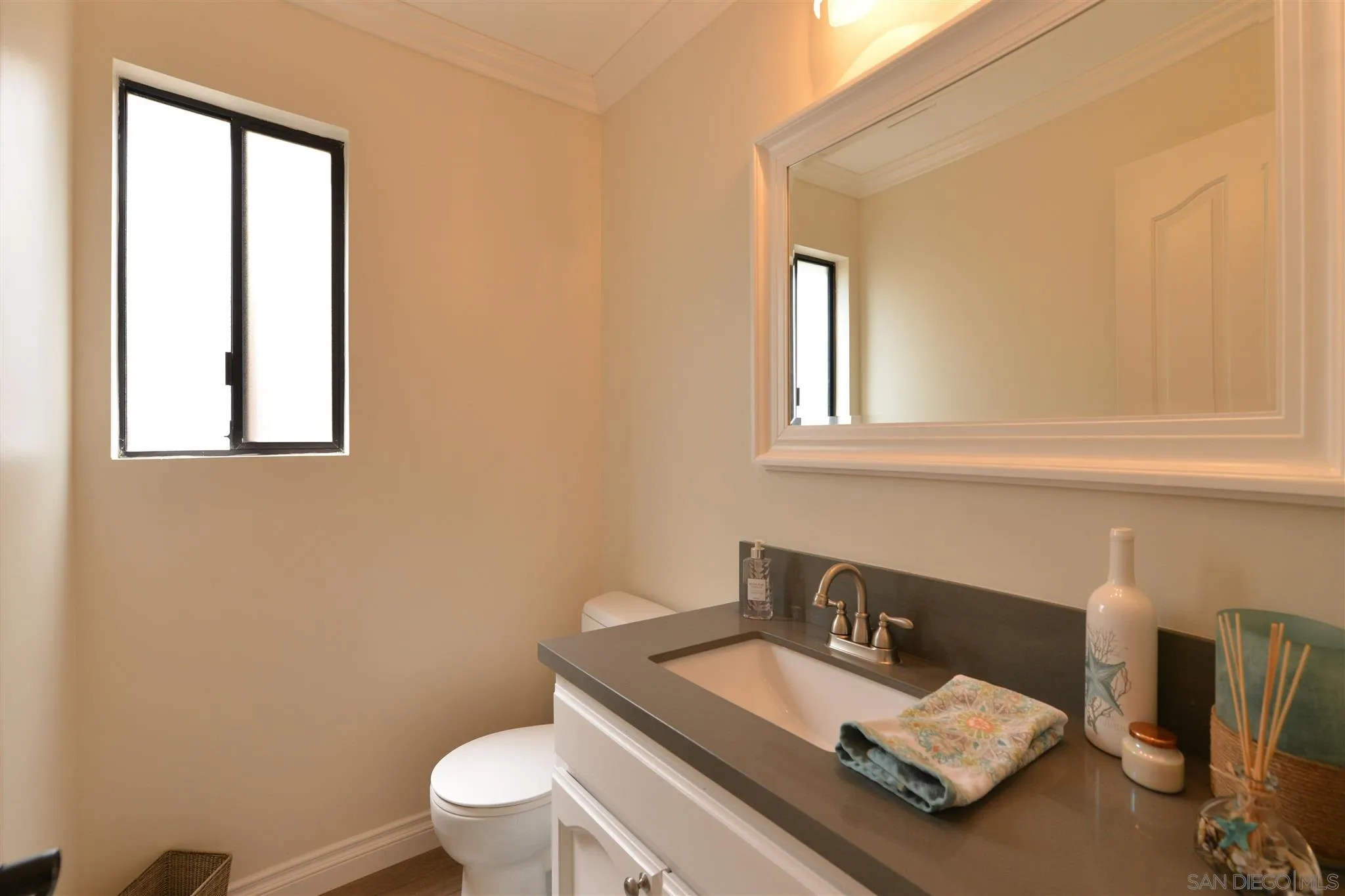554 E Coronado, CA 92118 - Photo 8 of 13 a bathroom with a sink vanity mirror and toilet