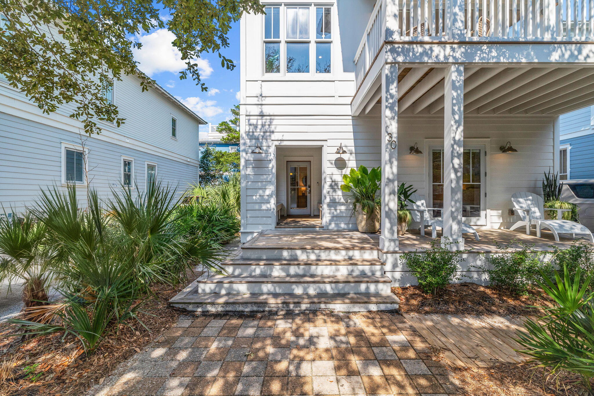 30 Chelsea Loop Road Santa Rosa Beach, FL 32459 - Photo 4 of 67 a view of a house with potted plants and a table and chairs